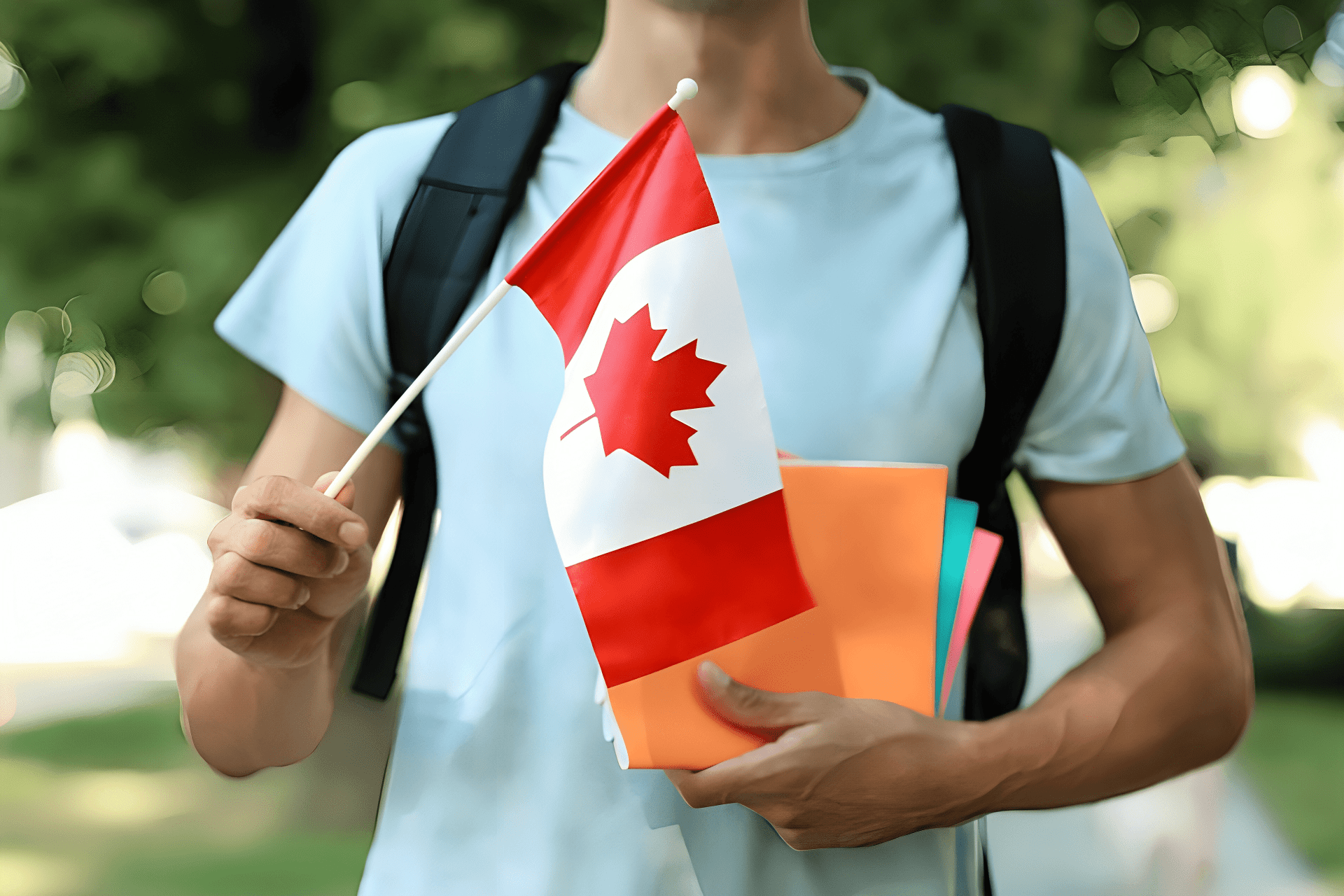 An international student holding a flag of Canada outdoors