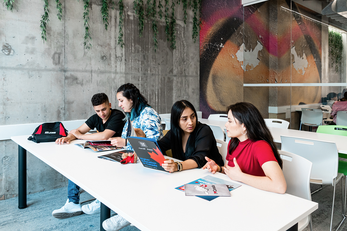 International students review brochures about graduate degree programs in Canada