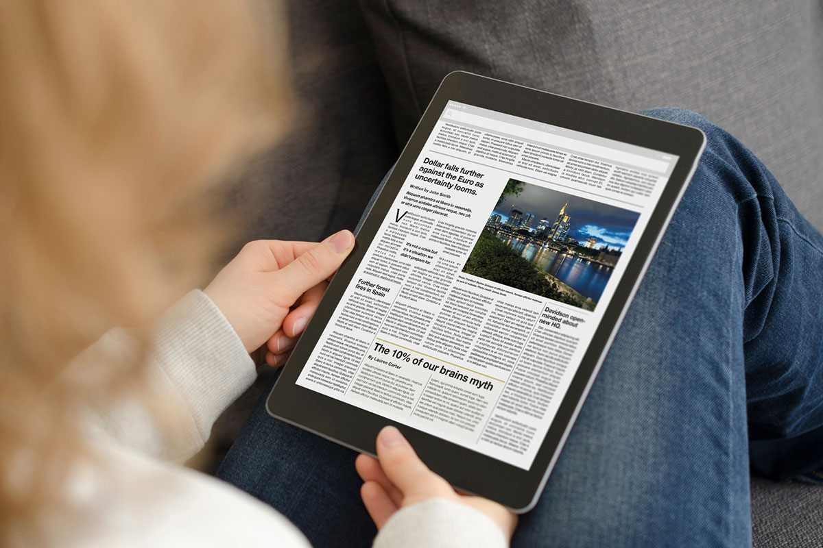 A person reading the news on a tablet