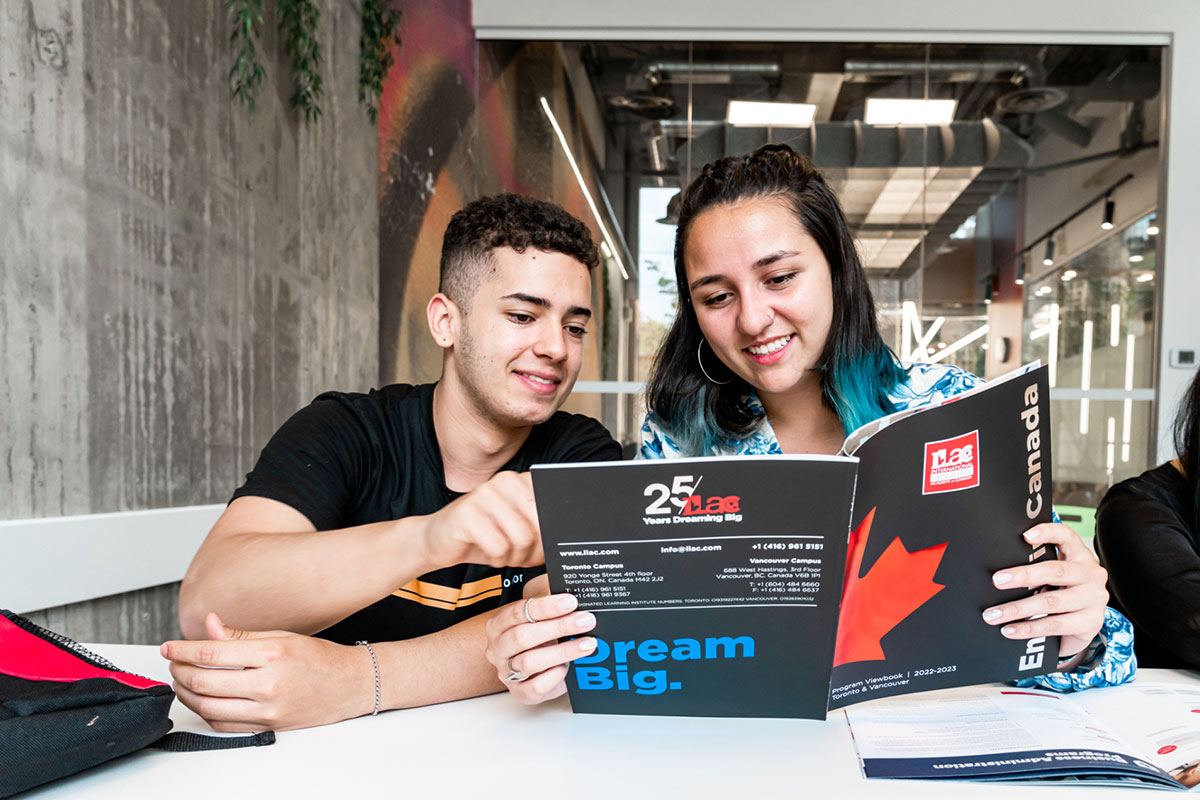 Conversation partners reading about studying business English at ILAC