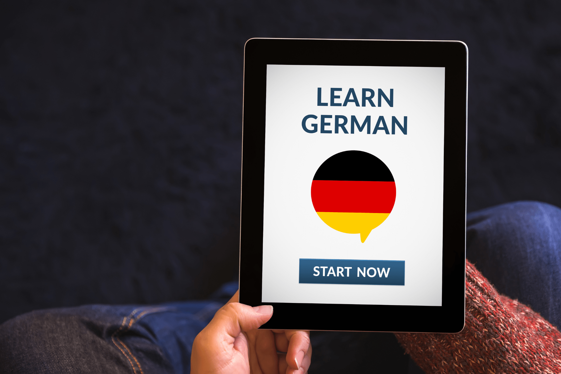 A tablet showing a language-learning app teaching German