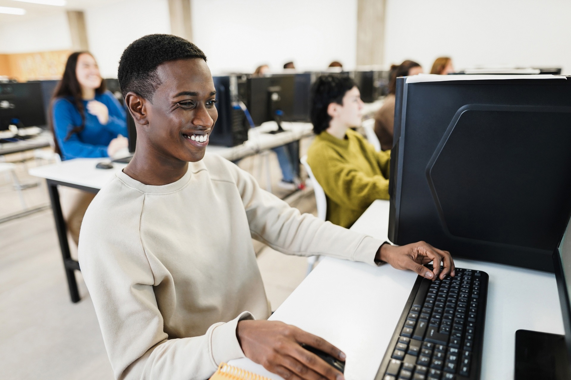 Male student taking a computer-delivered test in a test centre
