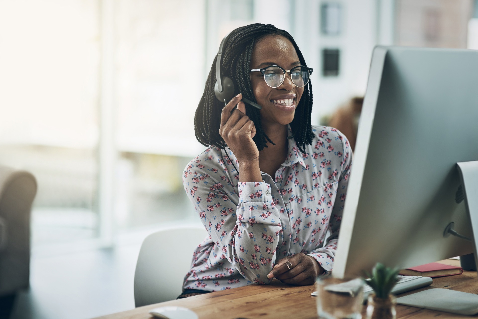 Customer service professional speaking to a client through a headset